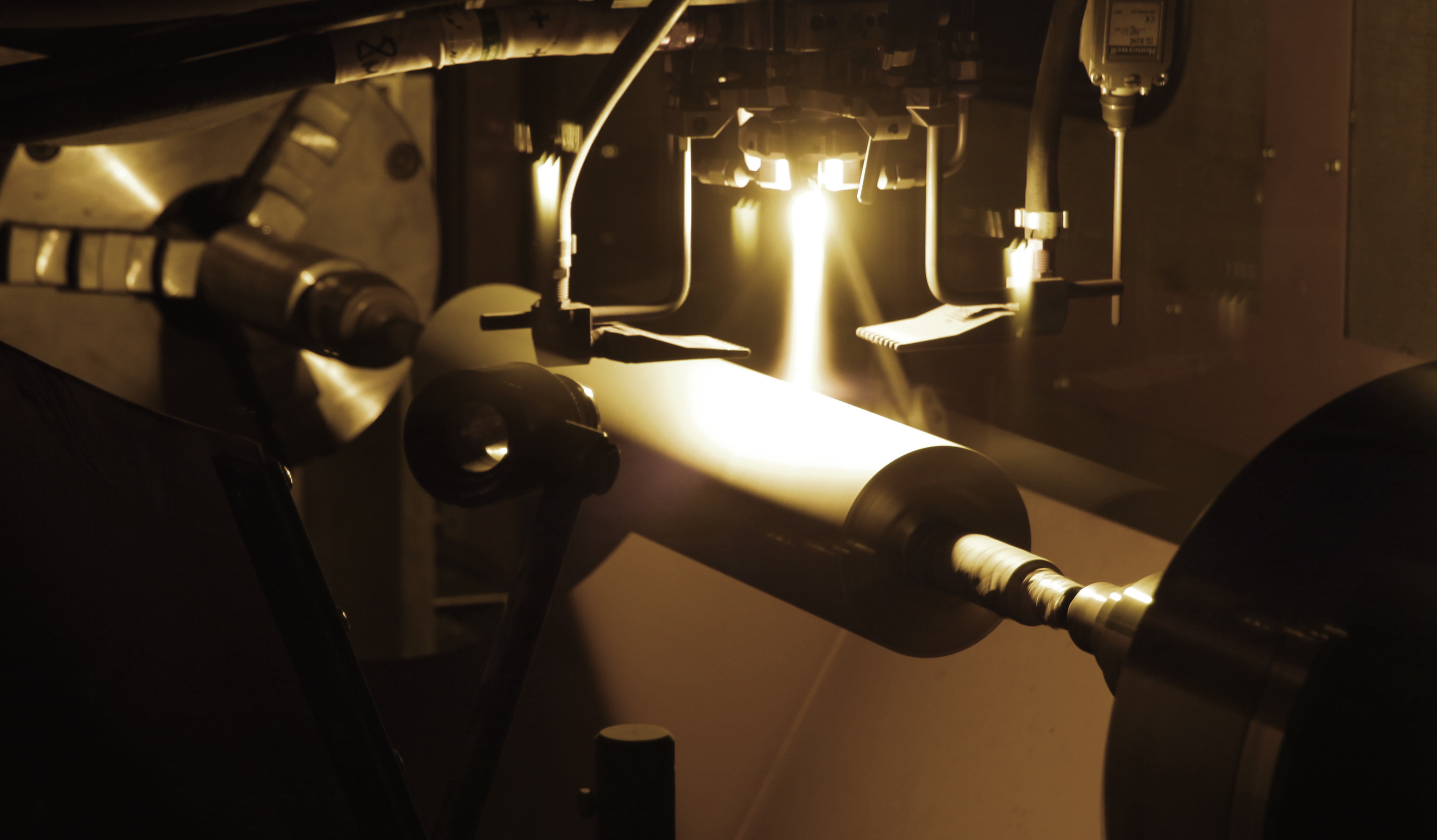 Laser and plasma coating process applied to an anilox roll during precision manufacturing.